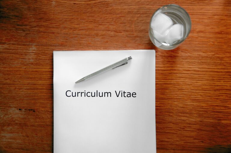 A Curriculum Vitae on desk.